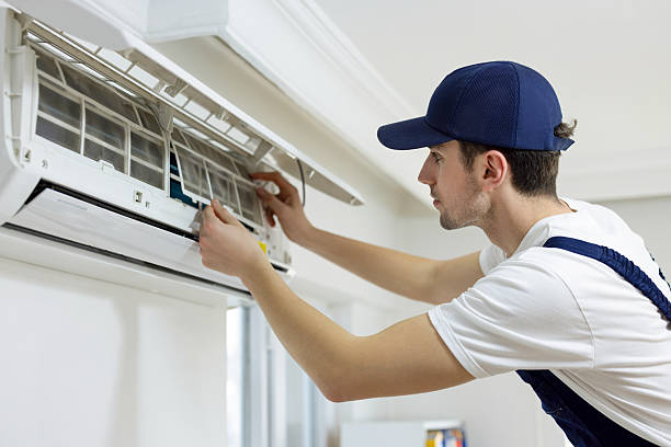 air conditioner technician repairing central air conditioning system